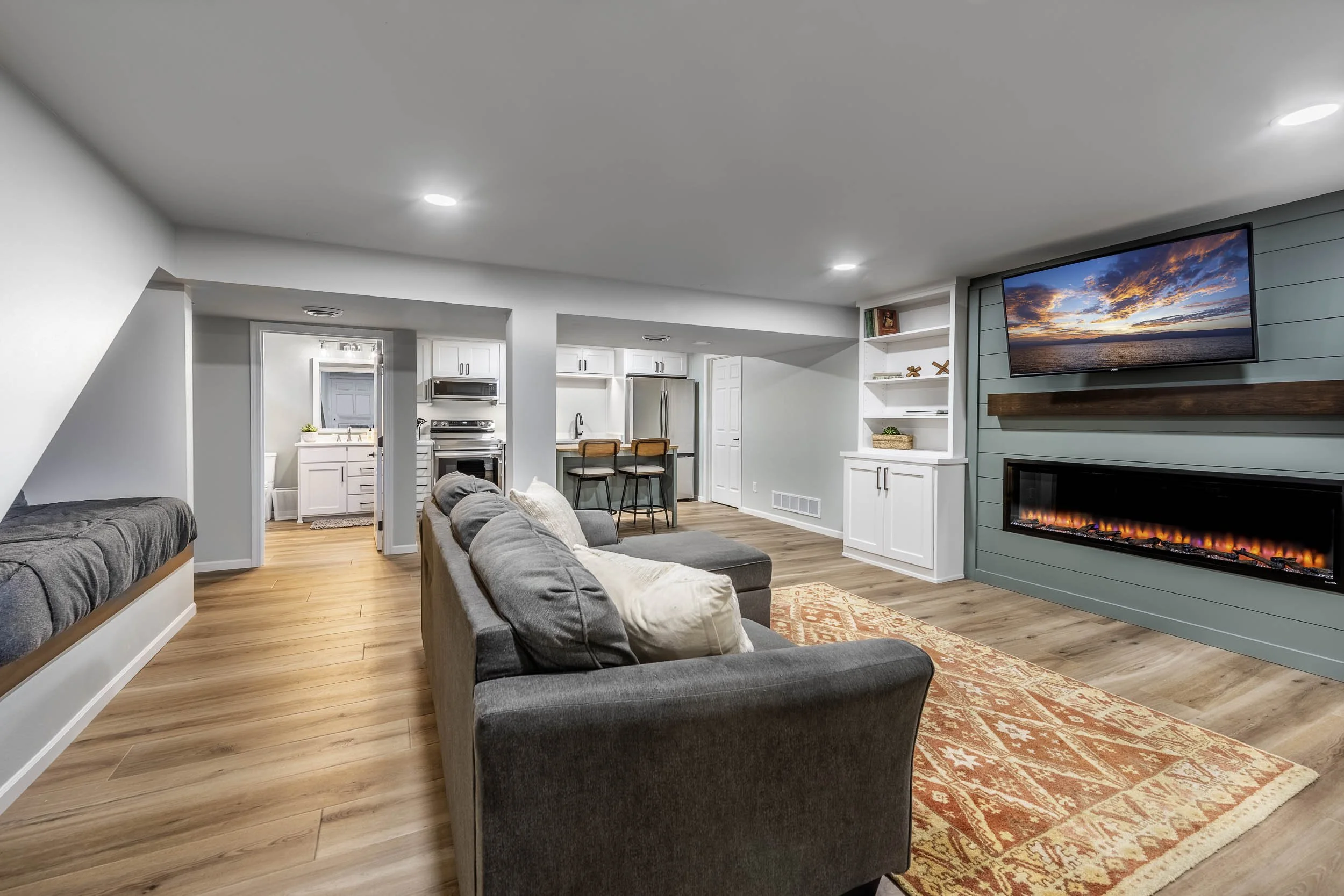 Finished basement remodel in Shrewsbury MA with open living space and fireplace