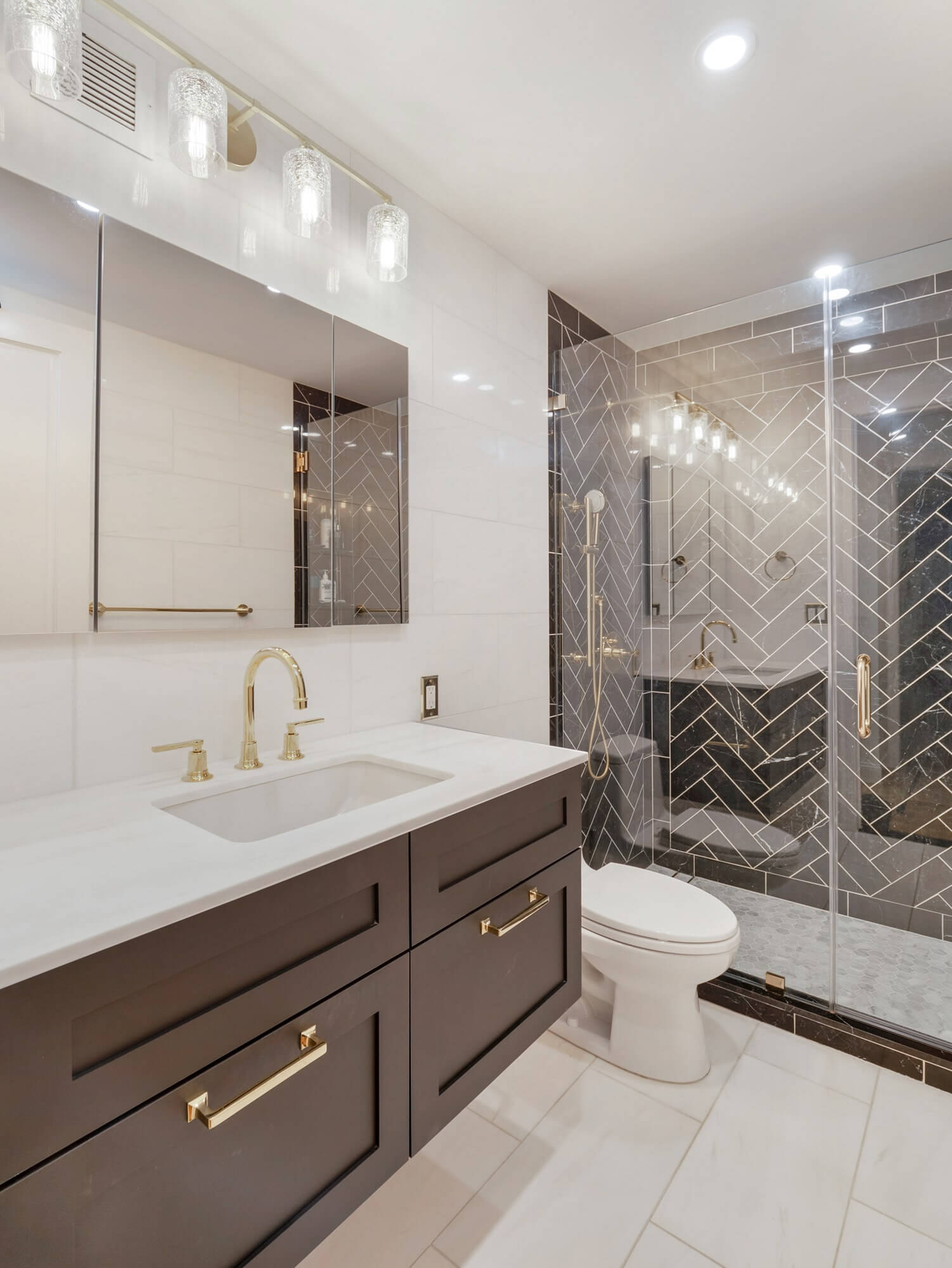 Bathroom remodel Worcester MA with dark vanity glass shower and modern tile by Prosper Construction